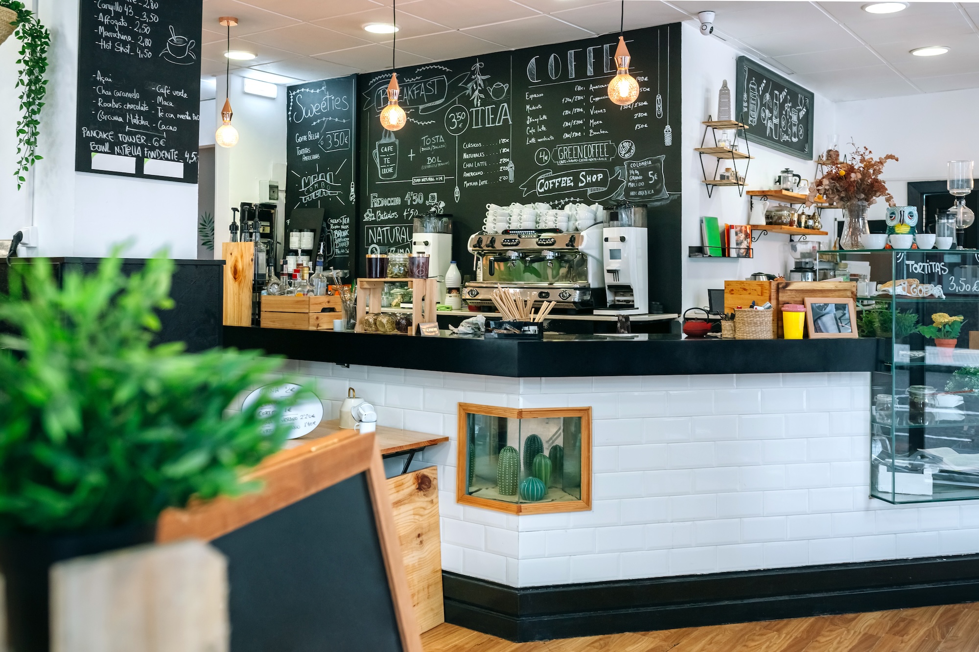 Empty cafe interior with coffee maker and blackboard with menu